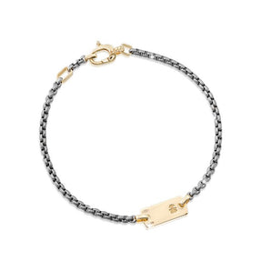 Bracciale in titanio con piastrina
e moschettone in oro giallo
con incisione femminuccia